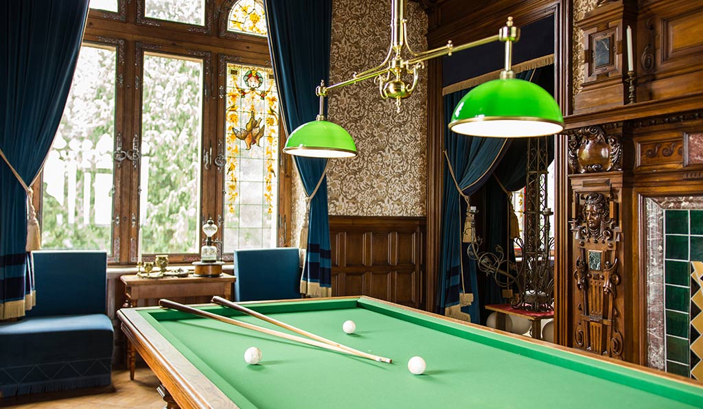 Snooker table or pool table inside a traditional property near a window